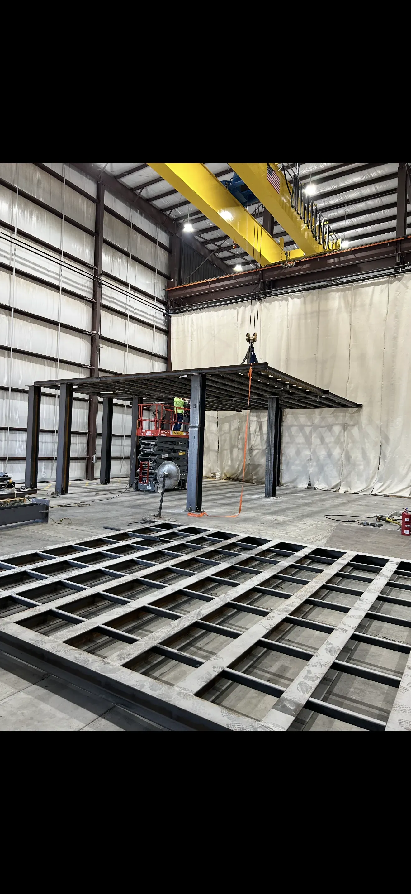 Metal framework in a warehouse being assembled with an overhead crane in Las Vegas.